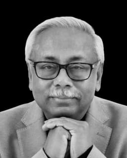 Suvo Sarkar, host of Money Majlis, in a black and white portrait with hands clasped beneath the chin
